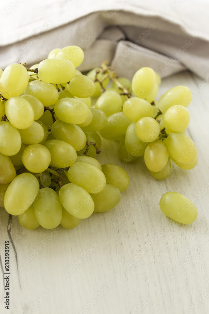 a bunch of grapes on a wooden background a bunch of grapes on a wooden background