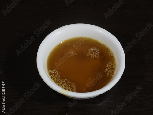 Indian Brown Mustard Seeds and oil,Yellow Mustard Seeds and oil,Close up of brown mustard seed,with its extracted oil on a brown wooden surface in dark Gothic colors.Its oil Boosts Cardiac Health,Bene