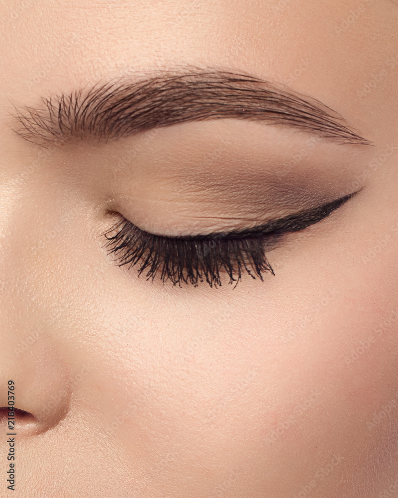 Cosmetics make-up. Beautiful female eye with sexy black liner makeup.  Fashion big arrow shape on woman's eyelid. Chic evening make-up Photos |  Adobe Stock