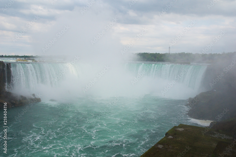 NIAGARA FALLS, ONTARIO, CANADA - MAY 20th 2018: Touristic boat on Horseshoe Falls, also known as Canadian Falls NIAGARA FALLS, ONTARIO, CANADA - MAY 20th 2018: Touristic boat on Horseshoe Falls, also known as Canadian Falls
