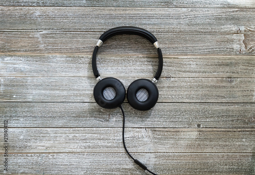 Headphones on a wooden desk overhead view photo