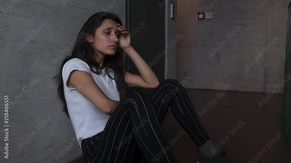 Sad Girl Sitting on Building Floor