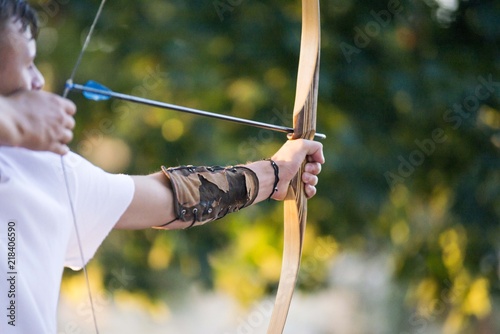 archer holding archery bow. archery sport background