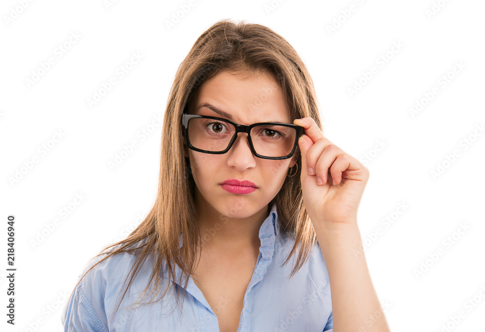 Doubtful woman looking at camera through eyeglasses