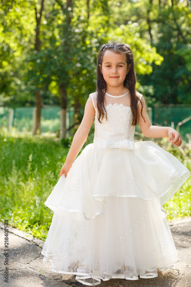 Little beautiful girl in the fashion dress in the park Little beautiful girl in the fashion dress in the park