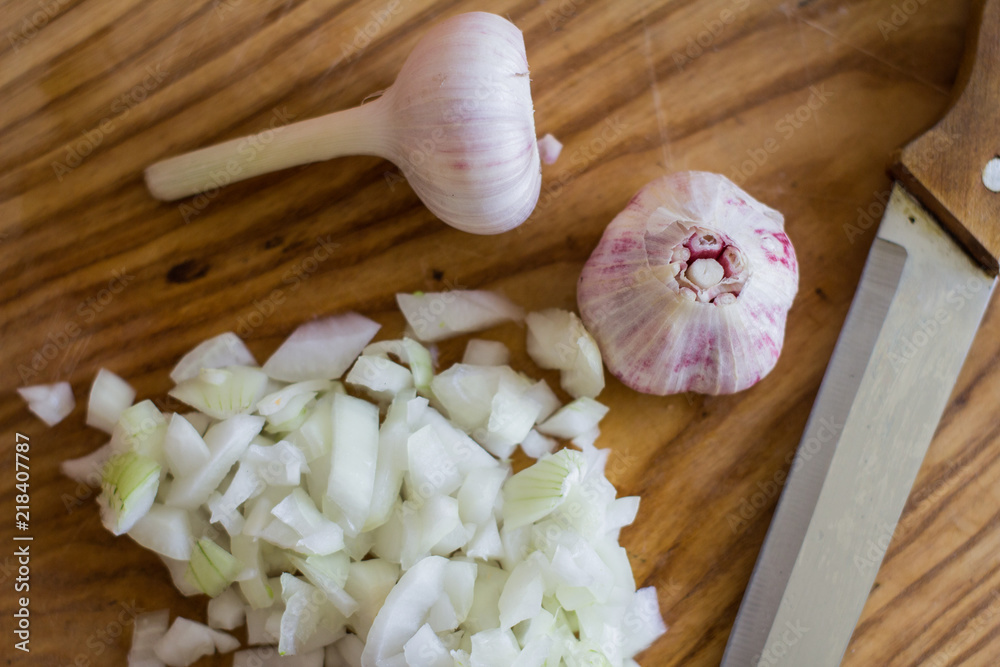 onion and garlic on wooden table onion and garlic on wooden table