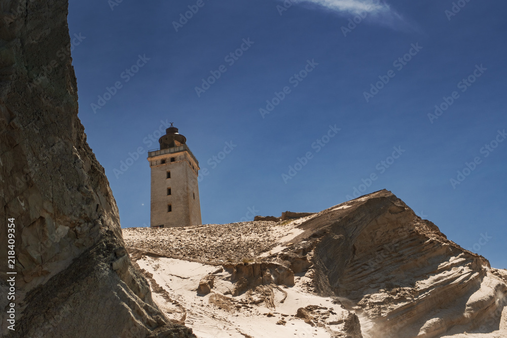 Famous lighthouse on the top of the sand dune cliffs in Northern Denmark. Rubjerg Knude Lighthouse, Lønstrup in North Jutland in Denmark, Skagerrak, North Sea Famous lighthouse on the top of the sand dune cliffs in Northern Denmark. Rubjerg Knude Lighthouse, Lønstrup in North Jutland in Denmark, Skagerrak, North Sea