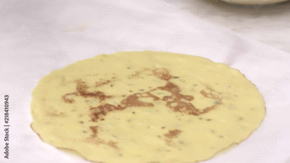 Pastry chef complete the crepes with chocolate and cream for the dinner party Pastry chef complete the crepes with chocolate and cream for the dinner party
