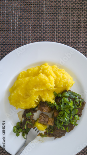 Potato pure Baroa with minced meat, garnished with chives. Healthy, appetizing and colorful food from the Brazilian Gastronomy in Sao Paulo State. photo