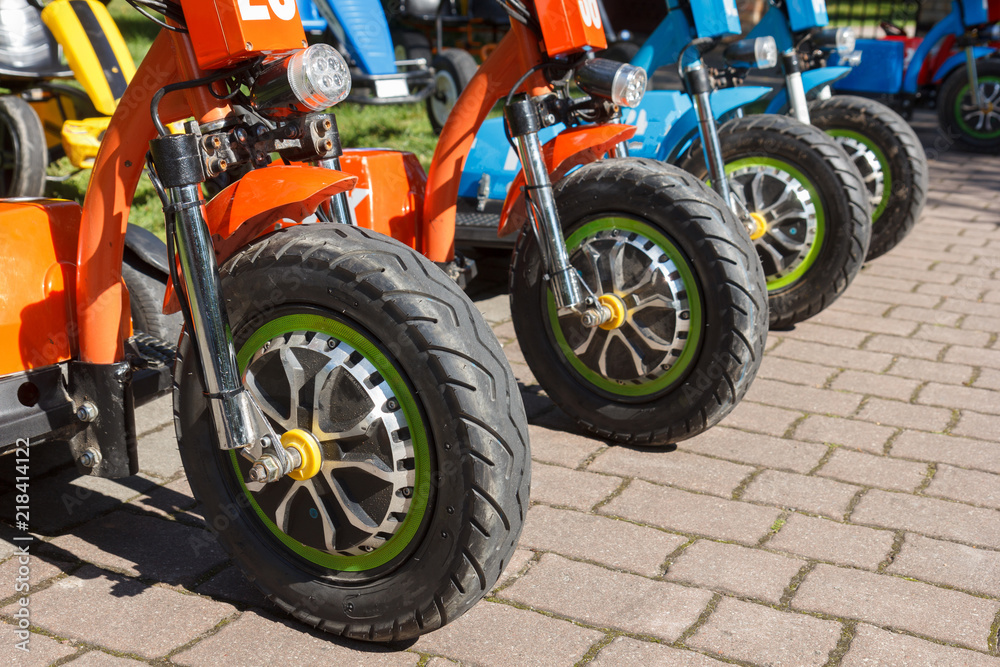 Obraz premium three wheel electric bicycle row in rental point