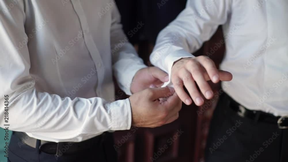 Man wearing cufflinks with friends (groom and bestman) Man wearing cufflinks with friends (groom and bestman)