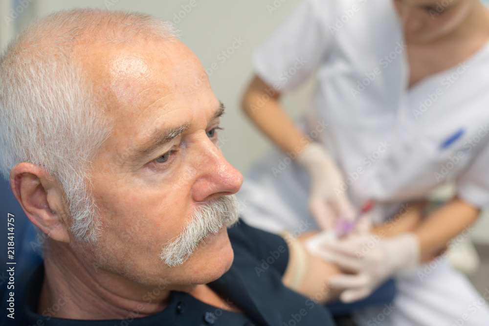 senior man receiving an insulin injection senior man receiving an insulin injection