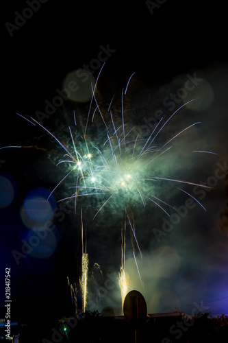 Green and blue firework. Amazing fireworks with bokeh from drops on the lens, fireworks 2019, fireworks background, fireworks event, Celebration in the town.