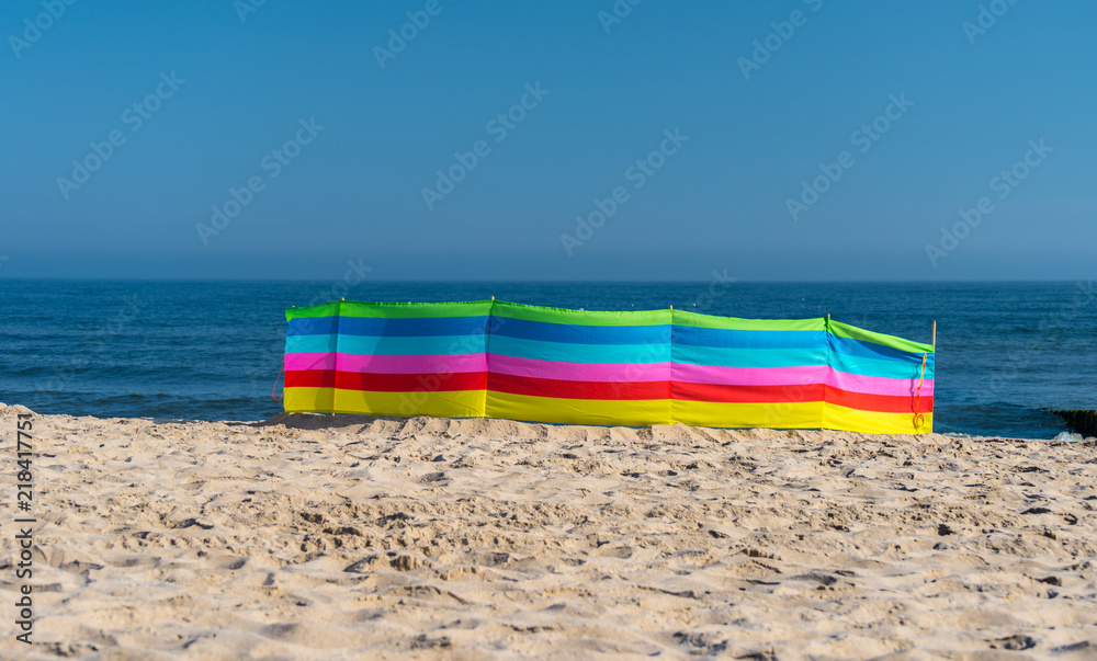 Beach screen on the Polish beach on a sunny summer day in the background beautiful sea. Beach screen on the Polish beach on a sunny summer day in the background beautiful sea.
