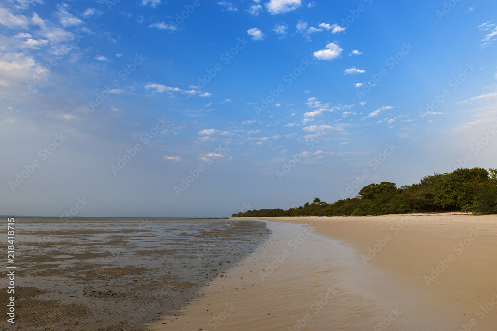 Deserted beach in the island of Orango at sunset, in Guinea Bissau. Orango is part of the Bijagos Archipelago; Concept for travel in Africa and summer vacations