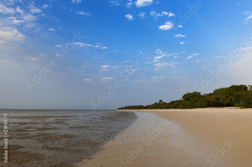 Fototapeta Naklejka Na Ścianę i Meble -  Deserted beach in the island of Orango at sunset, in Guinea Bissau. Orango is part of the Bijagos Archipelago; Concept for travel in Africa and summer vacations