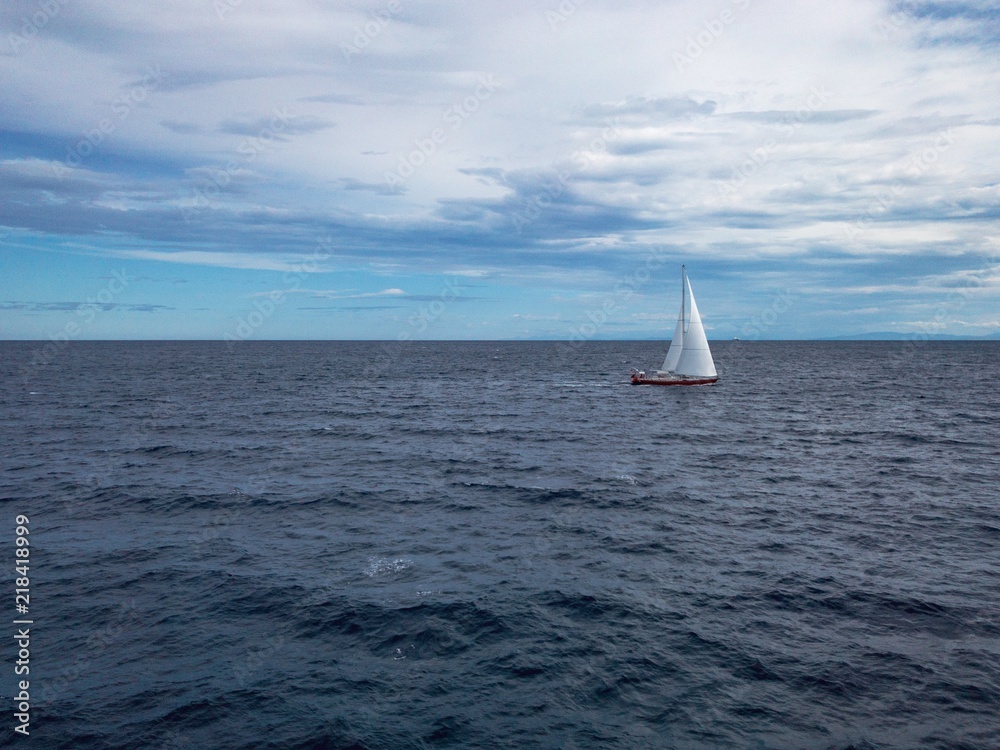 Obraz premium Sailing Boat in the sea with bright blue sky
