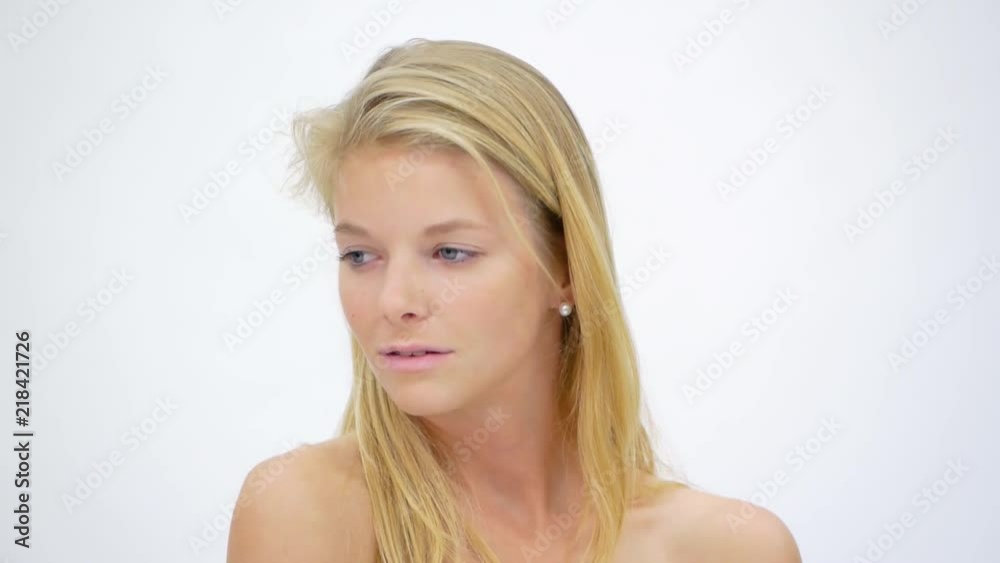 Young Girl Posing Near White Wall In Studio Young Girl Posing Near White Wall In Studio