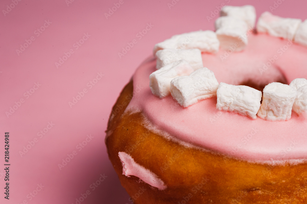 Pink donut with marshmallows on a Pink background Pink donut with marshmallows on a Pink background