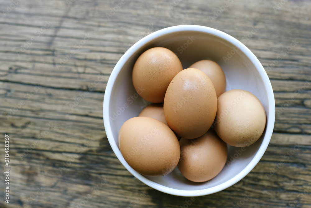 Fresh Brown Eggs Grouped in a White Bowl Fresh Brown Eggs Grouped in a White Bowl