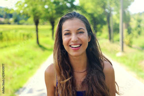 Happy cheerful young woman smiling outdoors. Fitness woman laughing after workout excercise.