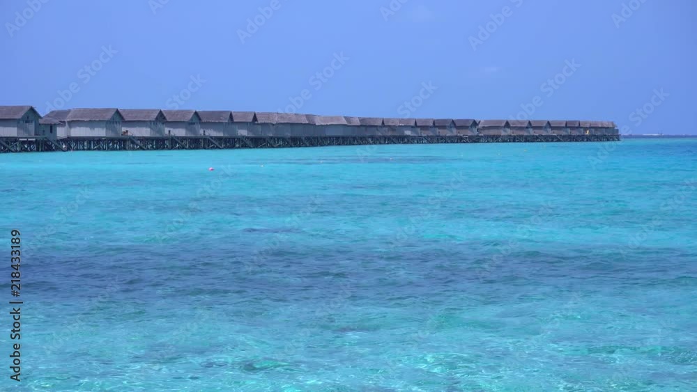 Tropical travel destination with pristine beach and water bungalows Tropical travel destination with pristine beach and water bungalows