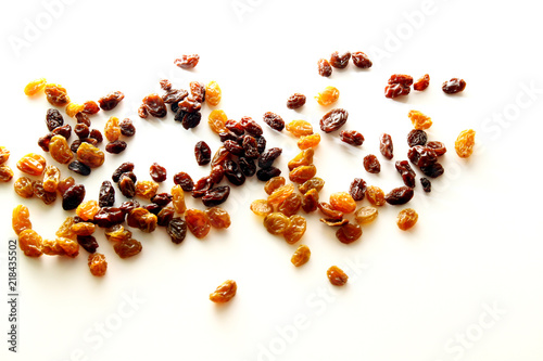 Raisins background / A raisin is a dried grape. Raisins are produced in many regions of the world and may be eaten raw or used in cooking, baking, and brewing.