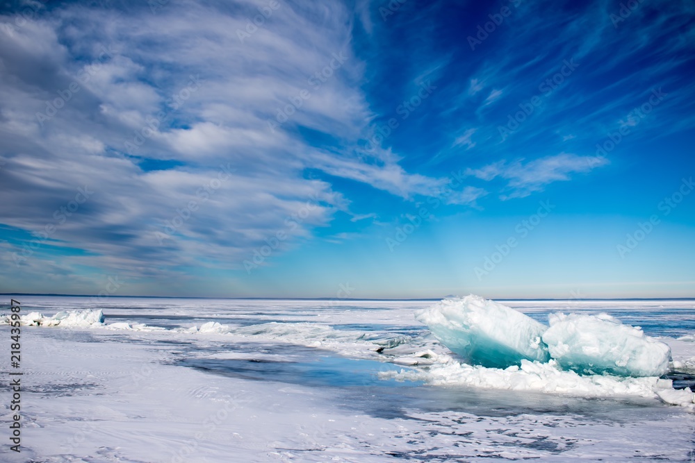 Blue turquoise ice heaves on a frozen lake in Canada. Blue turquoise ice heaves on a frozen lake in Canada.