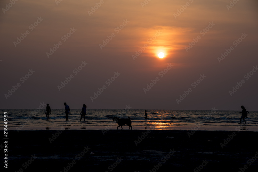 Silhouette  people on the beach at golden sunset time