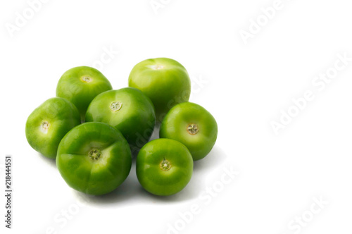 five green tomatoes in white