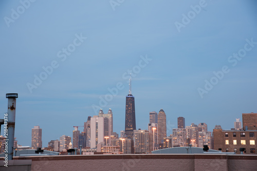 Chicago skyline at dusk as seen from a rooftop.