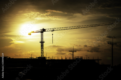 Silhouette crane with building Sunset light