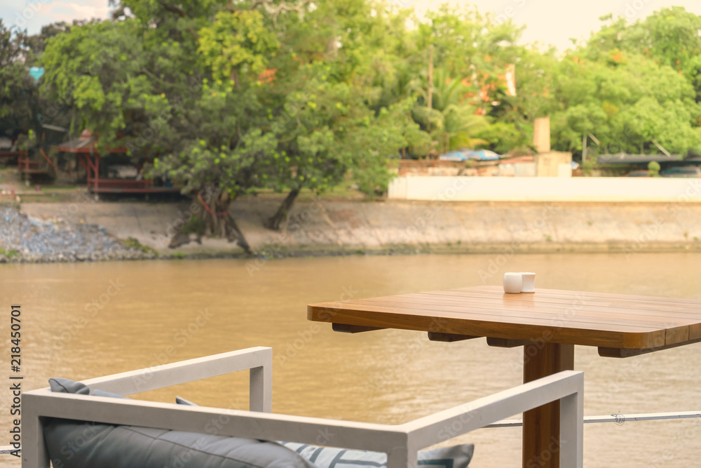 Outdoor table and chair with river background, vintage style,Ayutthaya,Ayutthaya historical park,Thailand, Relax concept