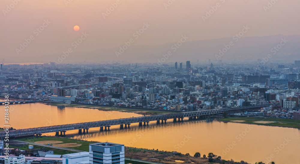 Osaka cityscapes with Yodo river at sunset. Scenery from Kuchu Teien Observatory on Umeda Sky Building.