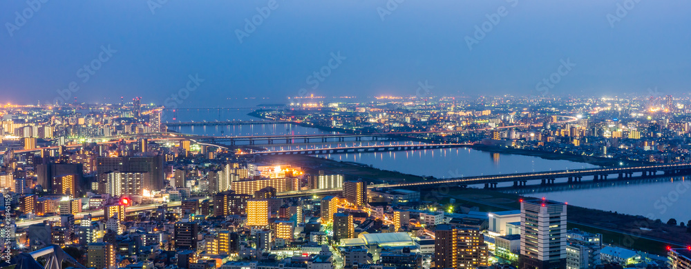 Osaka panorama cityscapes with Yodo river at night. Scenery from Kuchu Teien Observatory on Umeda Sky Building.