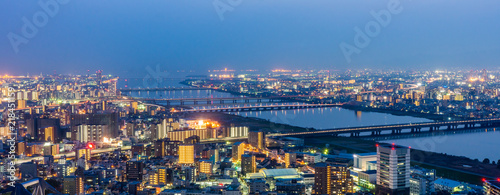 Osaka panorama cityscapes with Yodo river at night. Scenery from Kuchu Teien Observatory on Umeda Sky Building.
