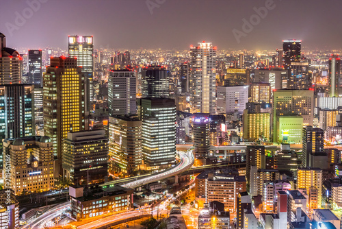 Osaka cityscapes with long traffic light trails at night. Scenery from Kuchu Teien Observatory on Umeda Sky Building.