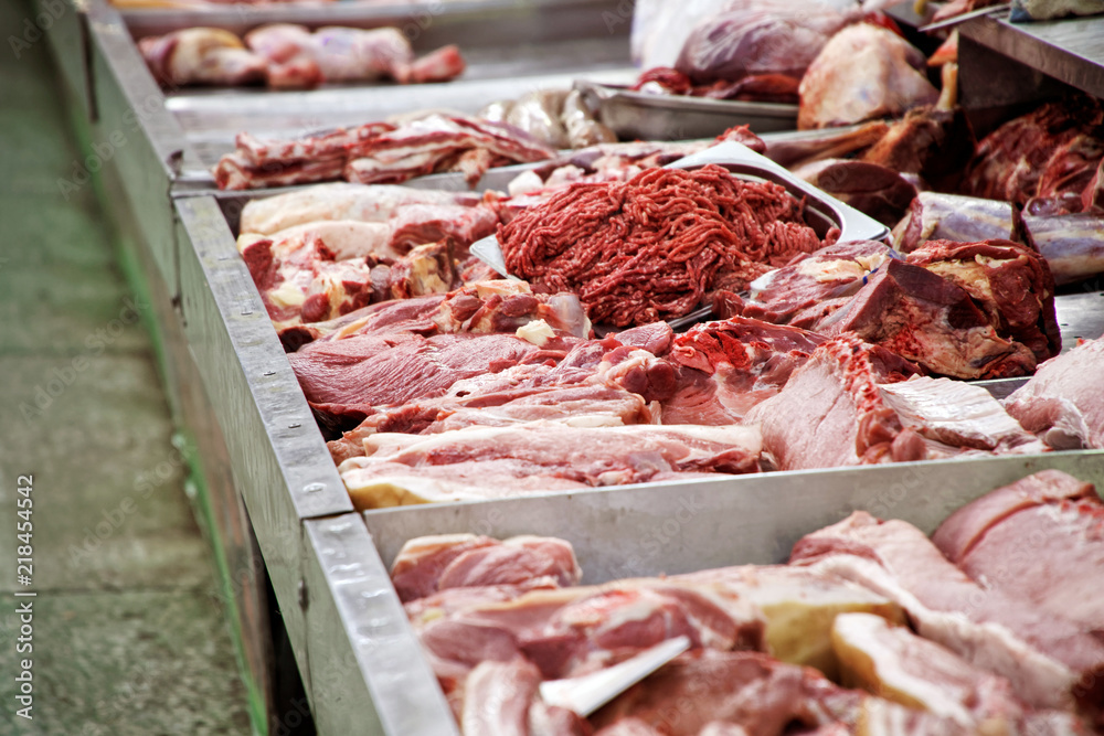 Meat shop: pieces of meat, ribs, bones and minced meat in the store.