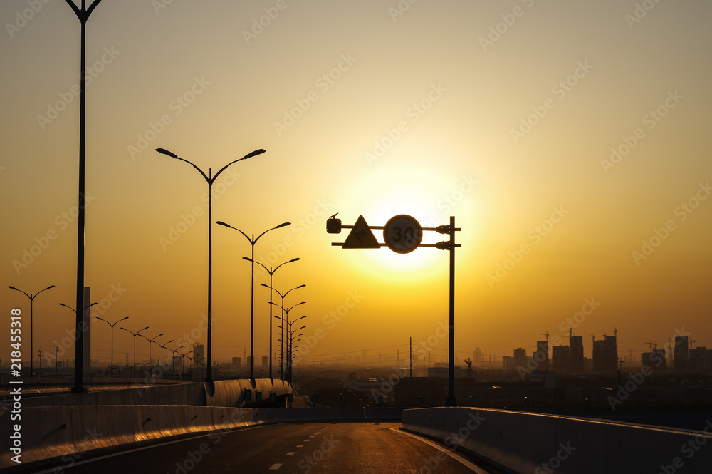 Traffic Signs in the Road at Sunset