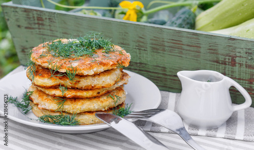 Delicious pancakes from courgettes and fresh vegetables with sour cream and dill