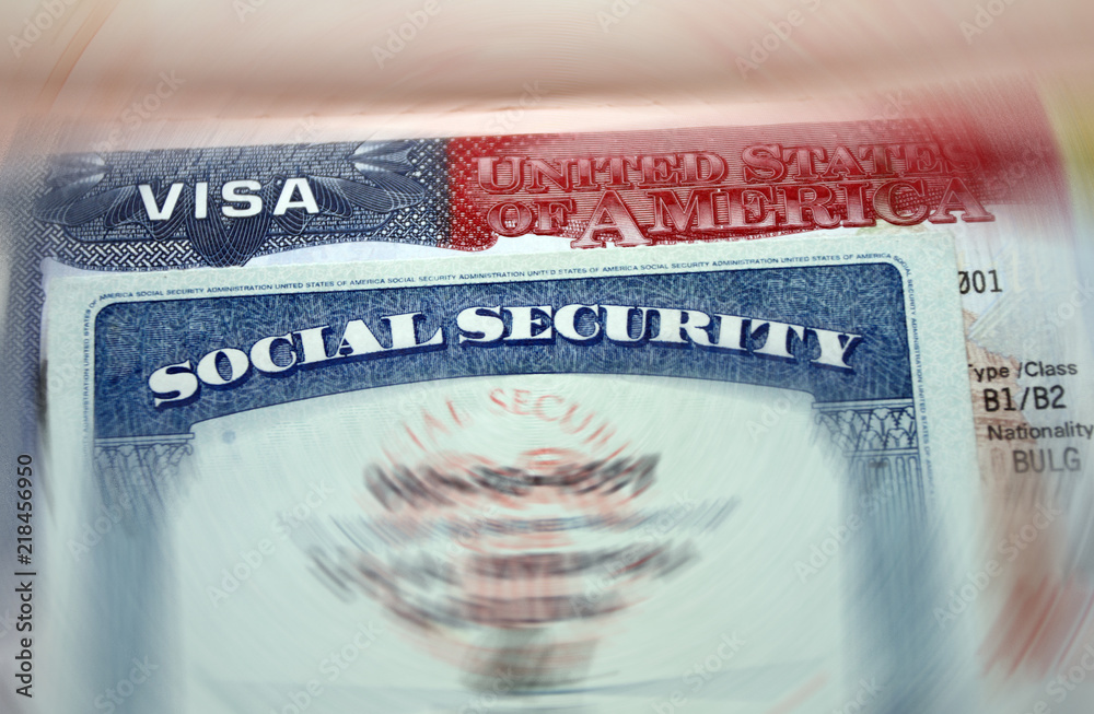 The American visa in a passport page (USA) background and sacial security  nember personal document. SSN – social security number for live in America  - selective focus Photos | Adobe Stock