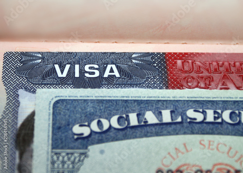 The American visa in a passport page (USA) background and sacial security nember personal document. SSN – social security number for live in America - selective focus photo