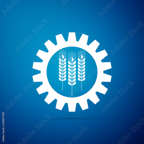 Wheat and gear icon isolated on blue background. Agriculture symbol with cereal grains and industrial gears. Industrial and agricultural. Biotechnology concept. Flat design. Vector Illustration