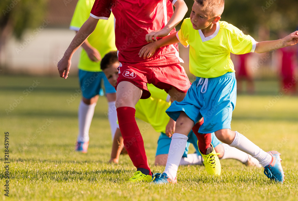 Young children players football match on soccer field Young children players football match on soccer field