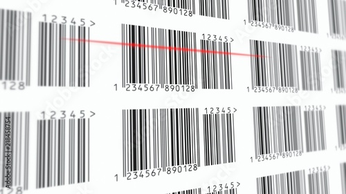 Scanning a barcode with a reader on a page filled with lines and numbers. Red scanline. Close-up shot.
 photo