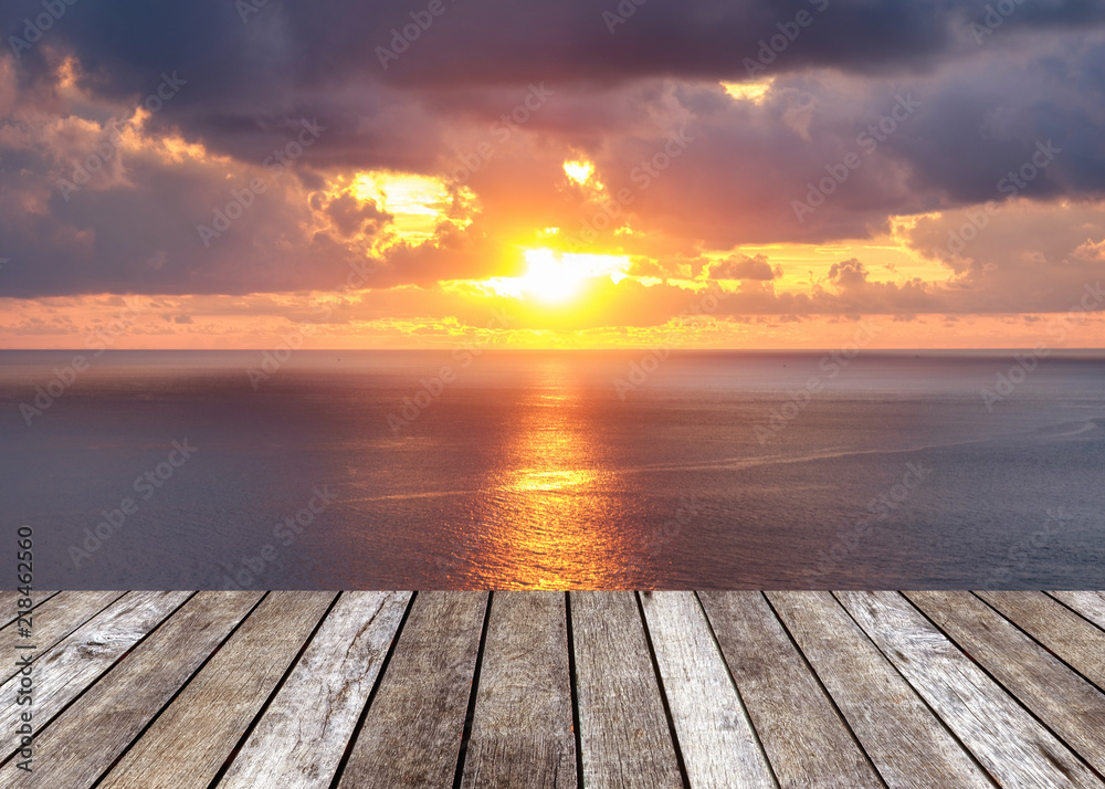 Wood table top on sunshine over sea in sunset