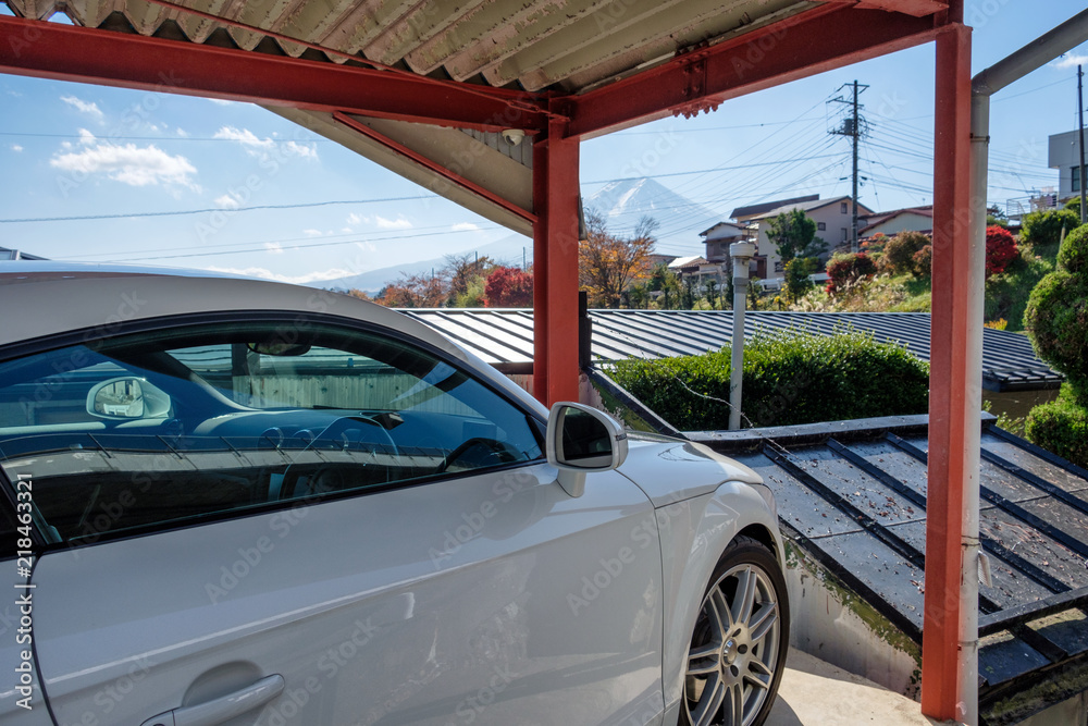 White modern sport car parked inside open garage and view Fuji-san mountain
