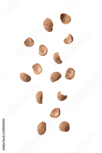 Chocolate cereals falling isolated on white background.