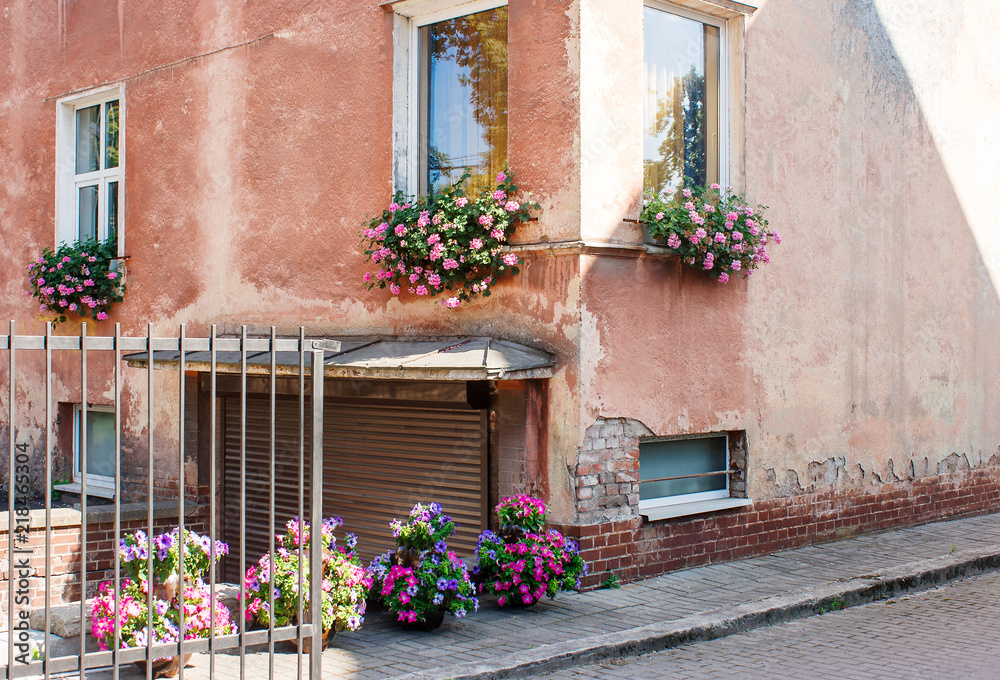 old house wall decorated with flowers