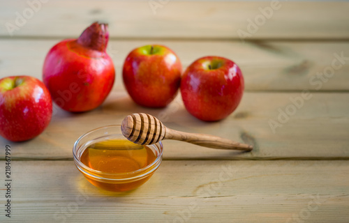 Apple and honey on wood deck, traditional food of jewish New Year - Rosh Hashana.  Selectiv focus. photo